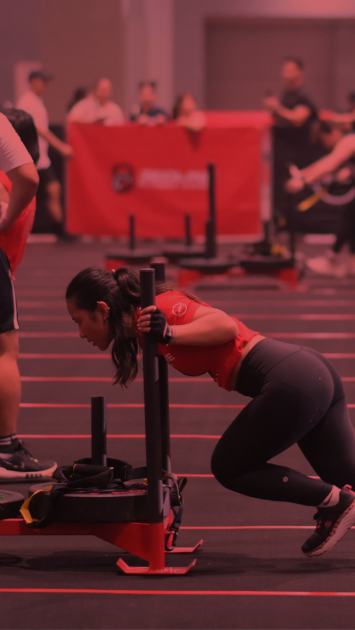 Competitor pushing a sled at Redline Fitness Games